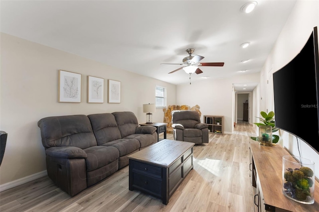 living room with ceiling fan and light hardwood / wood-style floors