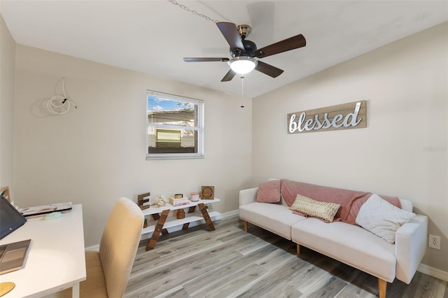 living room with light hardwood / wood-style floors, vaulted ceiling, and ceiling fan