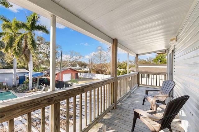 wooden deck featuring an outbuilding and a garage