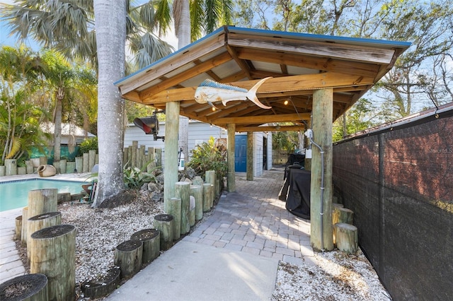 view of patio / terrace with a fenced in pool and a gazebo