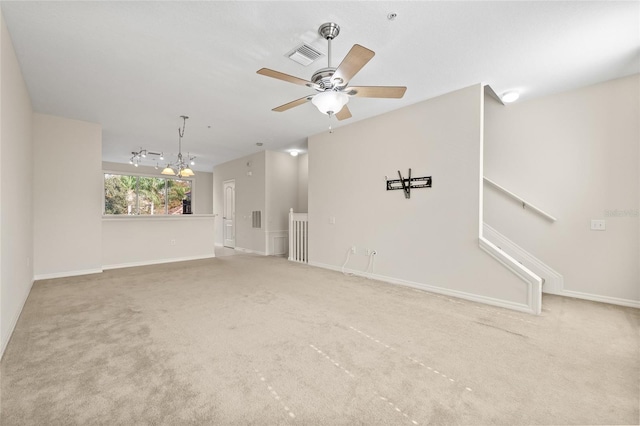 unfurnished room featuring carpet and ceiling fan with notable chandelier