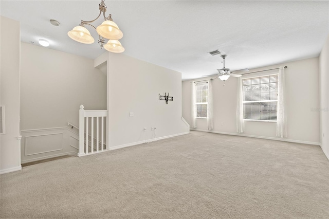 empty room featuring light colored carpet and ceiling fan