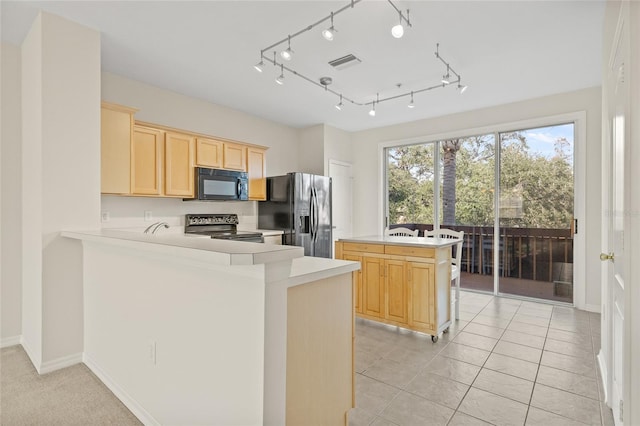 kitchen featuring light tile patterned flooring, black appliances, kitchen peninsula, and light brown cabinets