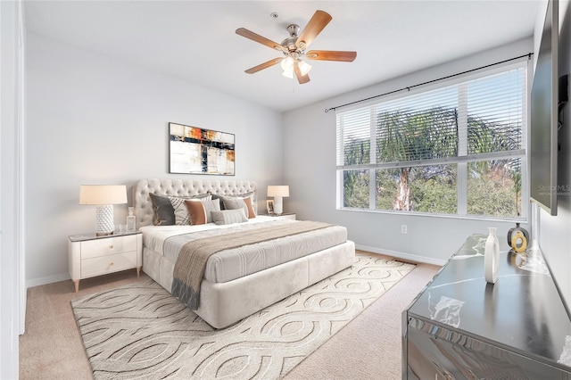 bedroom featuring ceiling fan and light carpet