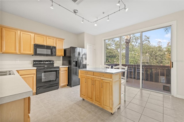 kitchen with a center island, sink, light brown cabinetry, and black appliances