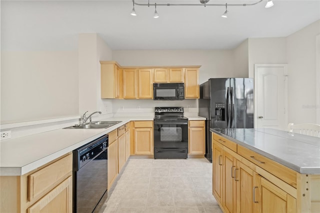 kitchen featuring light tile patterned floors, sink, light brown cabinets, and black appliances