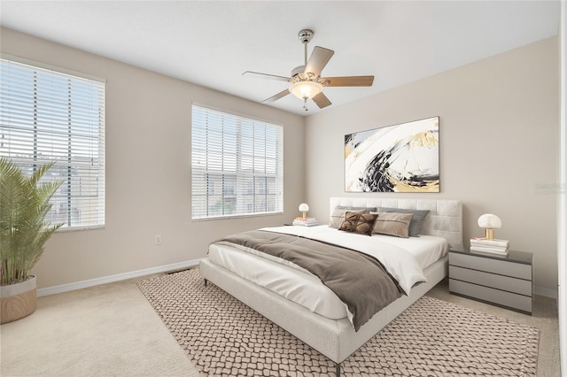 bedroom featuring light carpet and ceiling fan