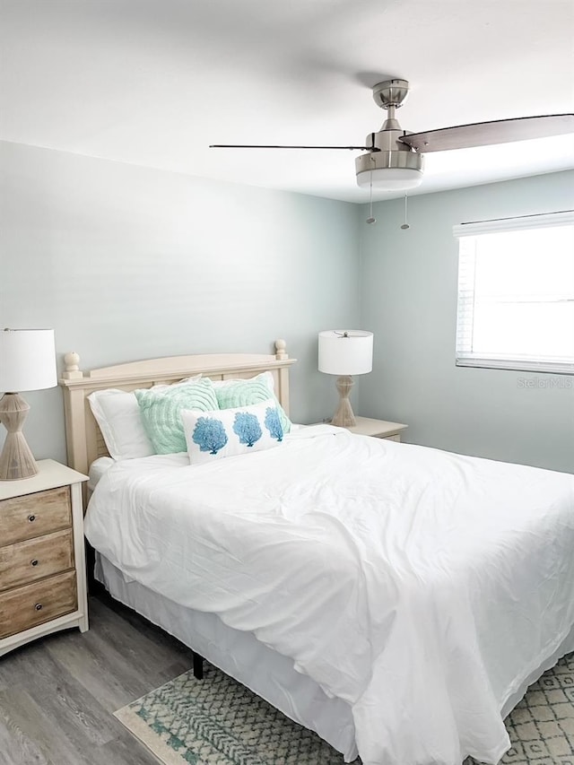 bedroom featuring ceiling fan and dark wood-type flooring