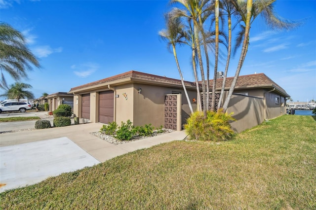 view of property exterior featuring a yard and a garage