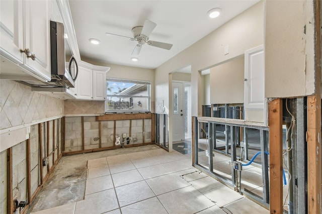 kitchen with white cabinets, decorative backsplash, ceiling fan, and light tile patterned flooring