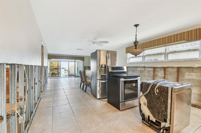 kitchen featuring appliances with stainless steel finishes, light tile patterned floors, a wealth of natural light, and ceiling fan