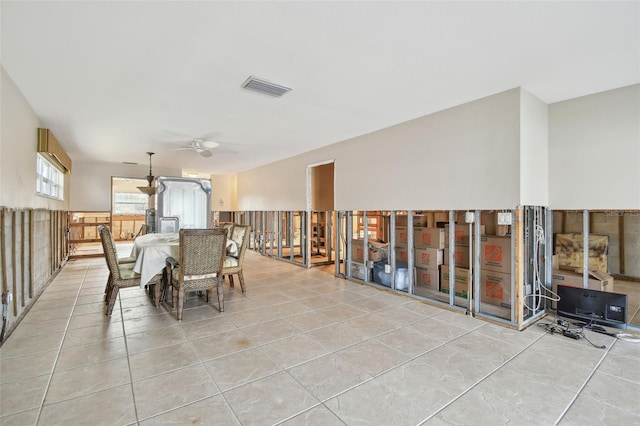 unfurnished dining area featuring ceiling fan and light tile patterned floors