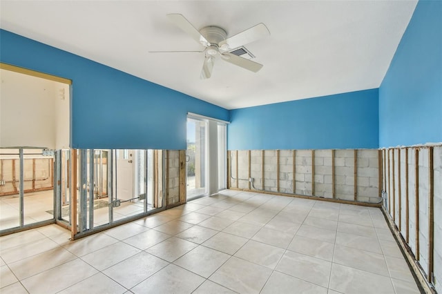 tiled empty room featuring ceiling fan