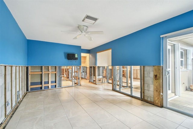 empty room featuring ceiling fan and light tile patterned floors