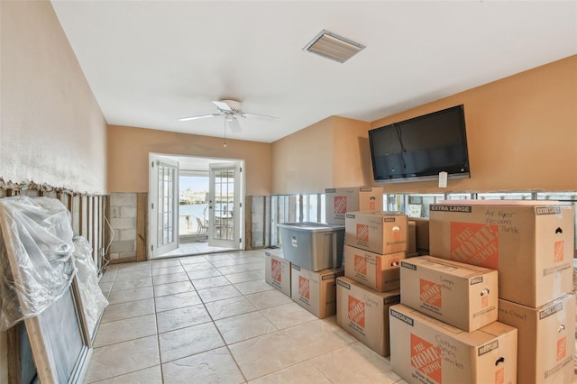 interior space with ceiling fan and french doors