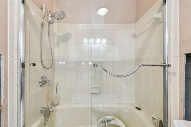 bathroom featuring combined bath / shower with glass door