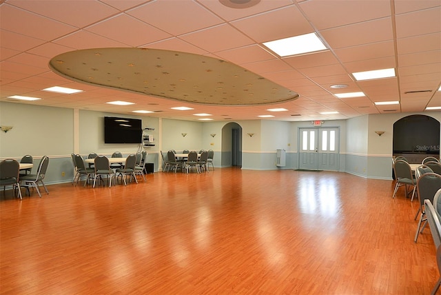 interior space with a paneled ceiling and wood-type flooring