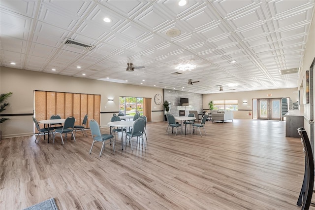 dining area with ceiling fan, a healthy amount of sunlight, and light wood-type flooring