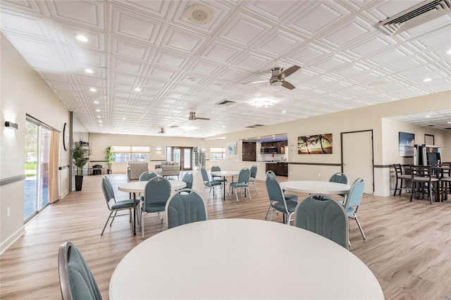 dining area with ceiling fan and light hardwood / wood-style floors