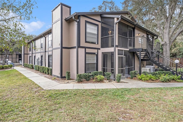 view of side of property with a lawn