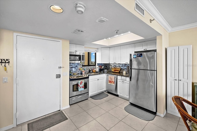 kitchen with white cabinetry, light tile patterned floors, and stainless steel appliances