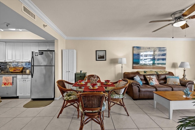 dining space with ceiling fan, light tile patterned floors, and ornamental molding