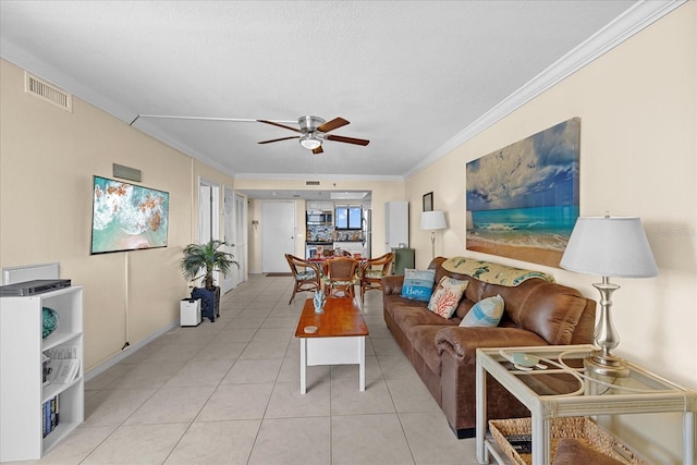 tiled living room featuring ceiling fan and ornamental molding