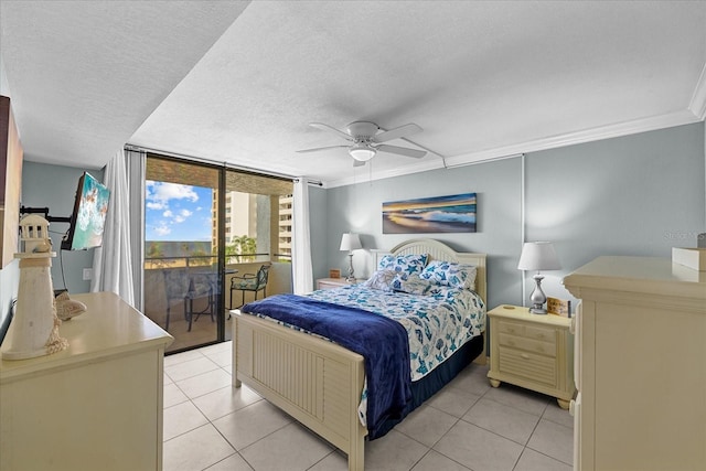 tiled bedroom with access to exterior, ceiling fan, expansive windows, crown molding, and a textured ceiling