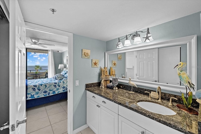 bathroom with ceiling fan, tile patterned flooring, and vanity