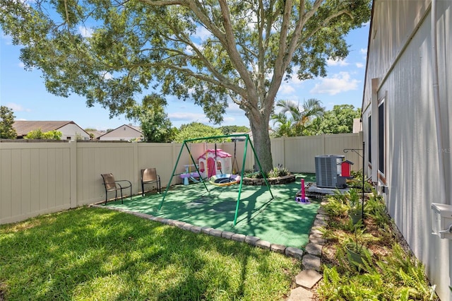 exterior space with central AC and a playground