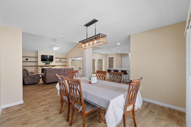 dining area with vaulted ceiling, light hardwood / wood-style floors, and ceiling fan