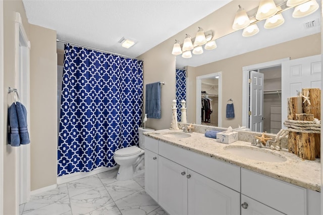 bathroom featuring vanity, toilet, curtained shower, and a textured ceiling