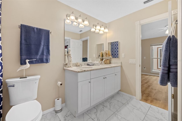 bathroom with vanity, ceiling fan, and toilet