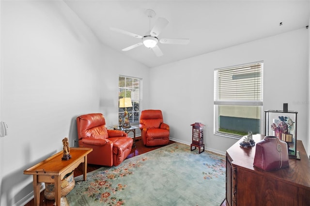 living area with hardwood / wood-style flooring, vaulted ceiling, and ceiling fan