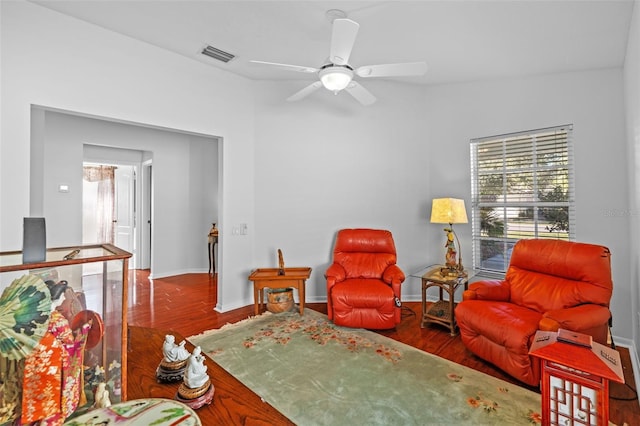 sitting room with hardwood / wood-style floors and ceiling fan