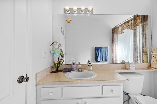 bathroom featuring vanity and toilet