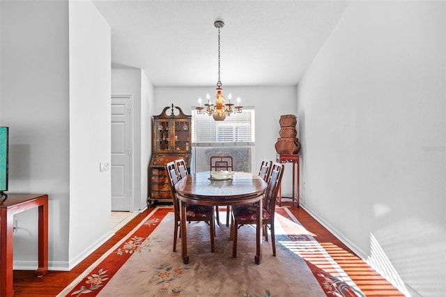 dining room with a chandelier and hardwood / wood-style floors