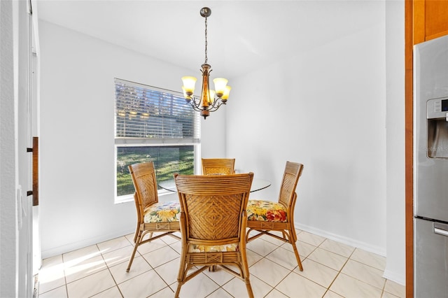 dining space with light tile patterned floors and an inviting chandelier