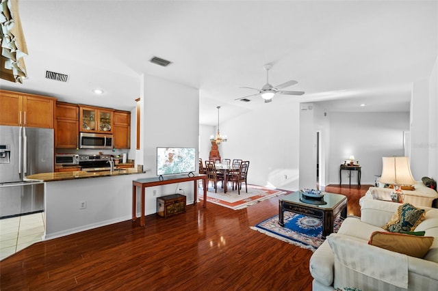 living room featuring ceiling fan and dark wood-type flooring