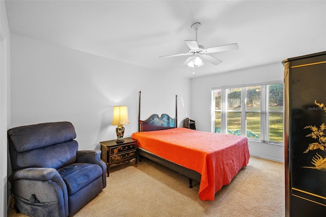 bedroom featuring ceiling fan and light colored carpet