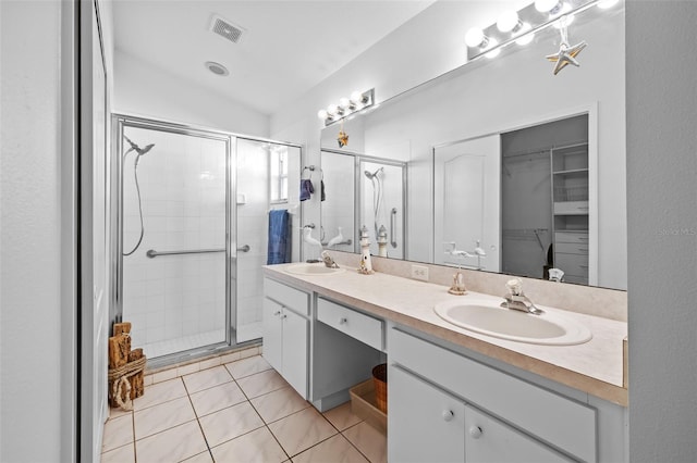 bathroom with tile patterned flooring, vanity, a shower with door, and lofted ceiling