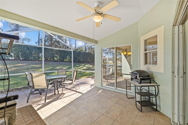 sunroom with ceiling fan and vaulted ceiling