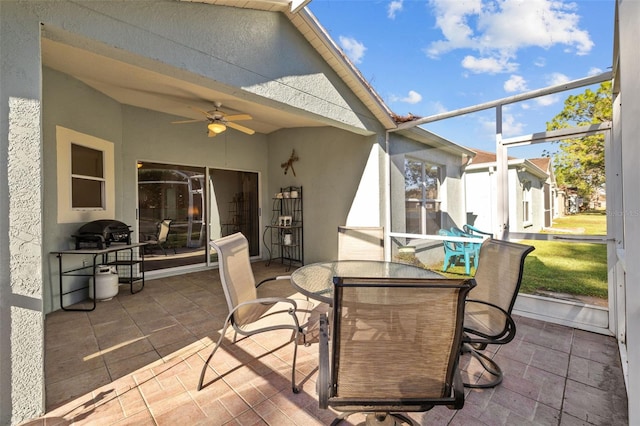 sunroom / solarium featuring ceiling fan and vaulted ceiling