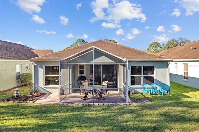 rear view of house with a lanai, a yard, and a patio