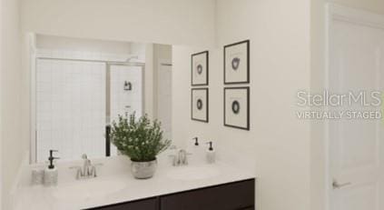 bathroom featuring vanity and a shower with shower door