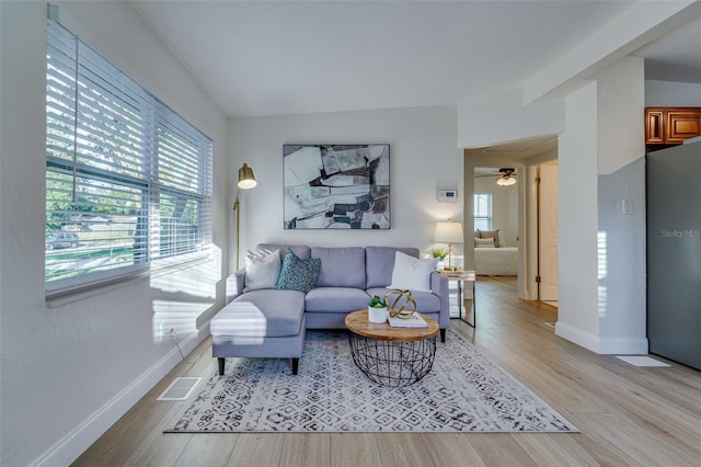 living room featuring ceiling fan, a healthy amount of sunlight, and light hardwood / wood-style floors