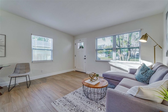 living room with vaulted ceiling and light hardwood / wood-style floors