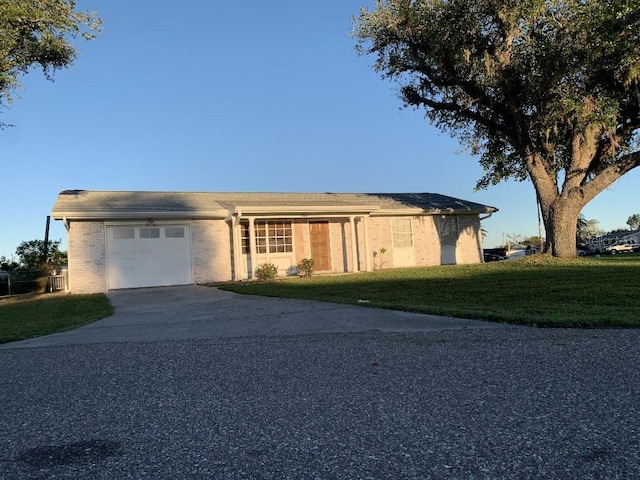 ranch-style house with a front lawn and a garage