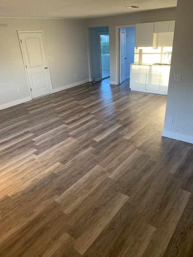 unfurnished living room with dark hardwood / wood-style floors