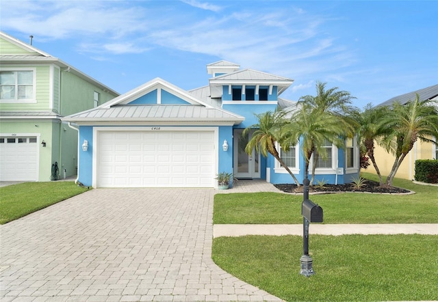 view of front of home with a garage and a front lawn